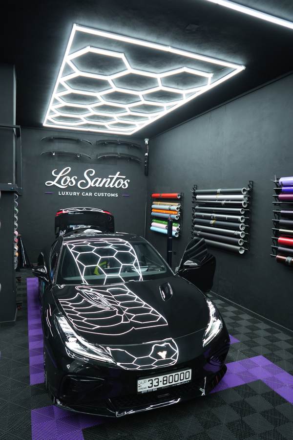 Black car in the bay under the hex ceiling