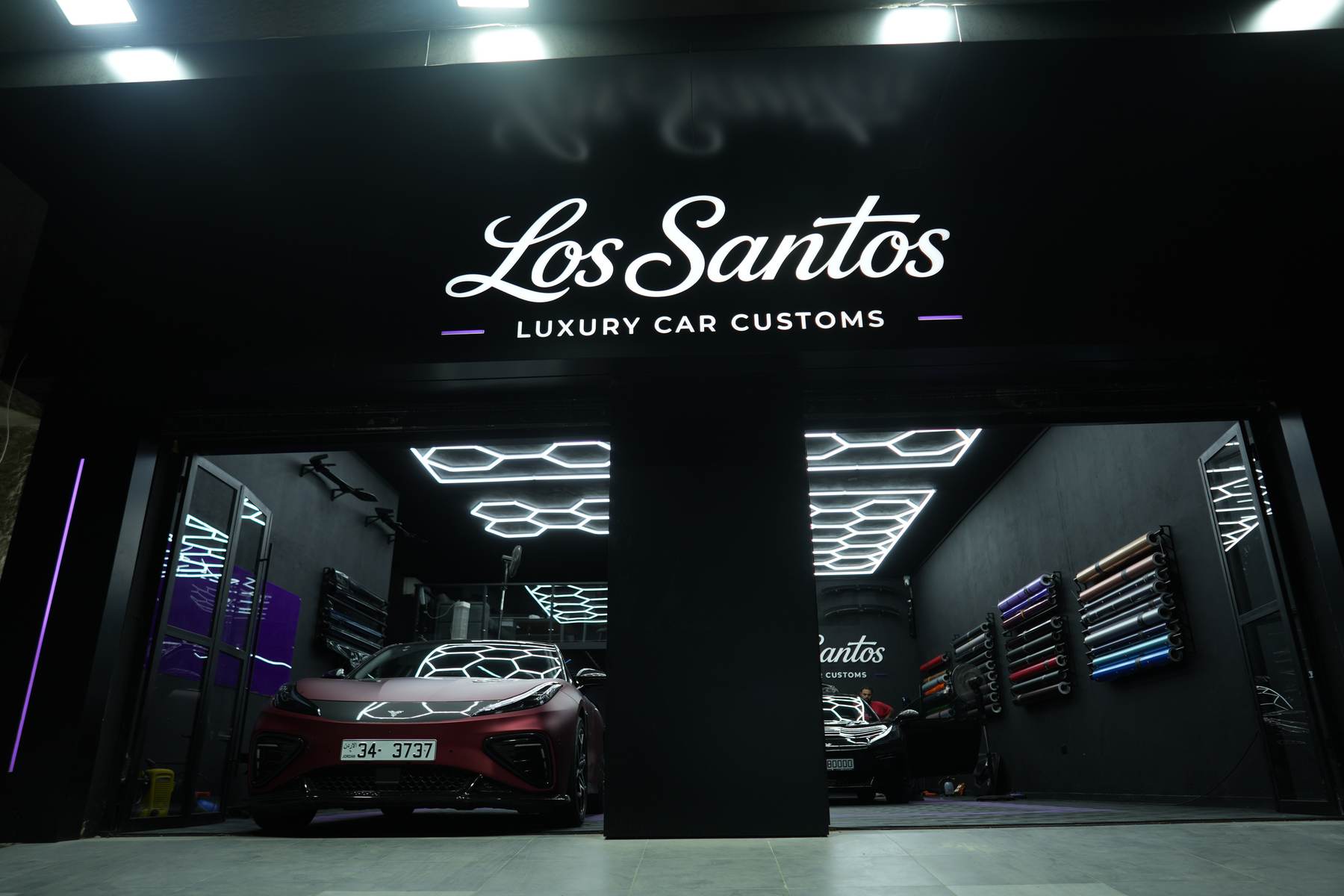 Los Santos Luxury Car Customs storefront at night