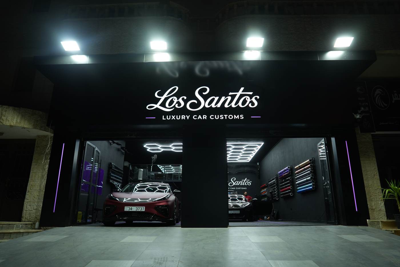 Los Santos storefront lit at night